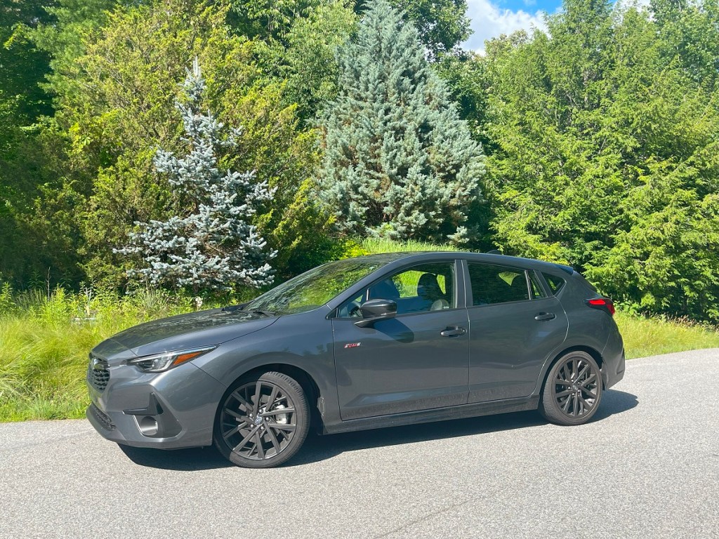 The 2024 Subaru Impreza parked in front of foliage 