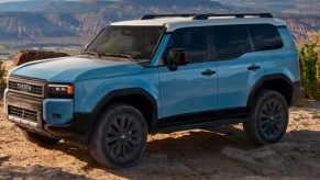 A blue 2024 Toyota Land Cruiser midsize SUV is parked outdoors.