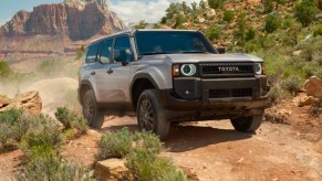 A gray 2024 Toyota Land Cruiser is driving off-road.