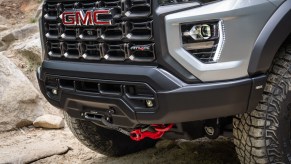 The 2024 GMC Canyon – Toyota Tacoma competitor – parked on a dusty and rocky road.