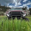 The front end of a 2024 Polaris Ranger XD in tall grass on the range.