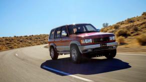 The Acura SLX full-size SUV (a rebadged Isuzu Trooper) model with Super Handling AWD driving on a desert road