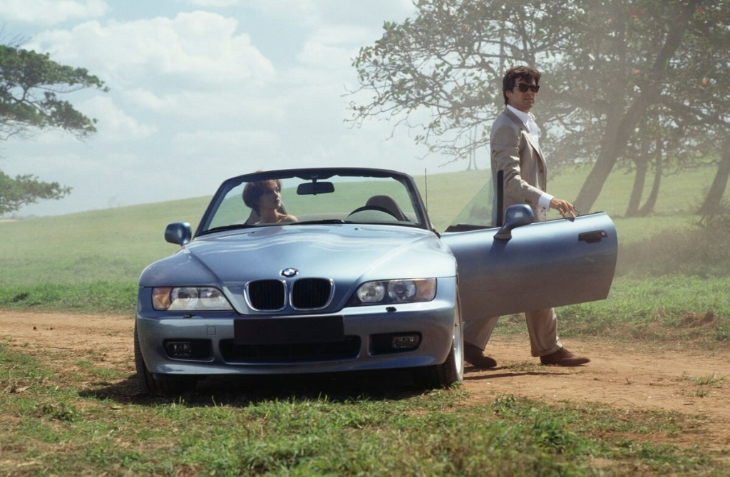 Pierce Brosnan and Izabella Scorupco pose with the movie car on set of a James Bond movie in a BMW Z3 rather than an Aston Martin.
