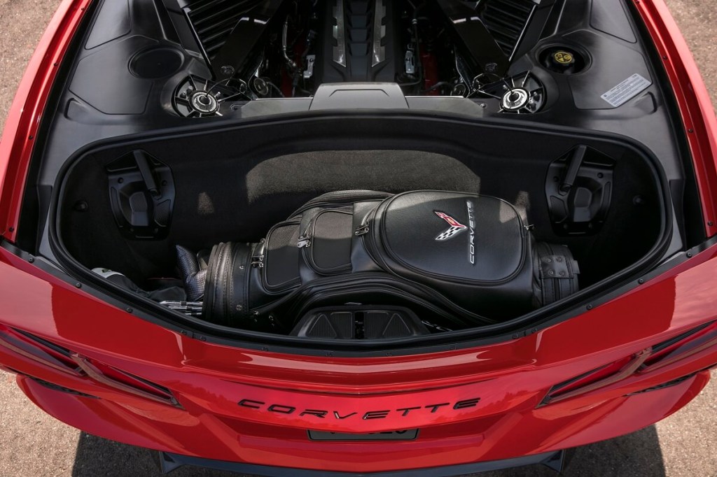 A Chevrolet Corvette shows off its sport car rear trunk with golf clubs. 