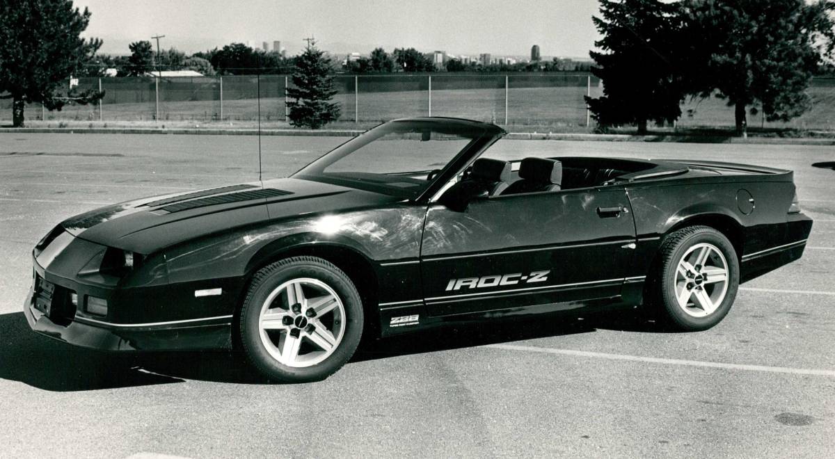 A black and white photo of a Chevrolet Camaro Iroc-Z on display.