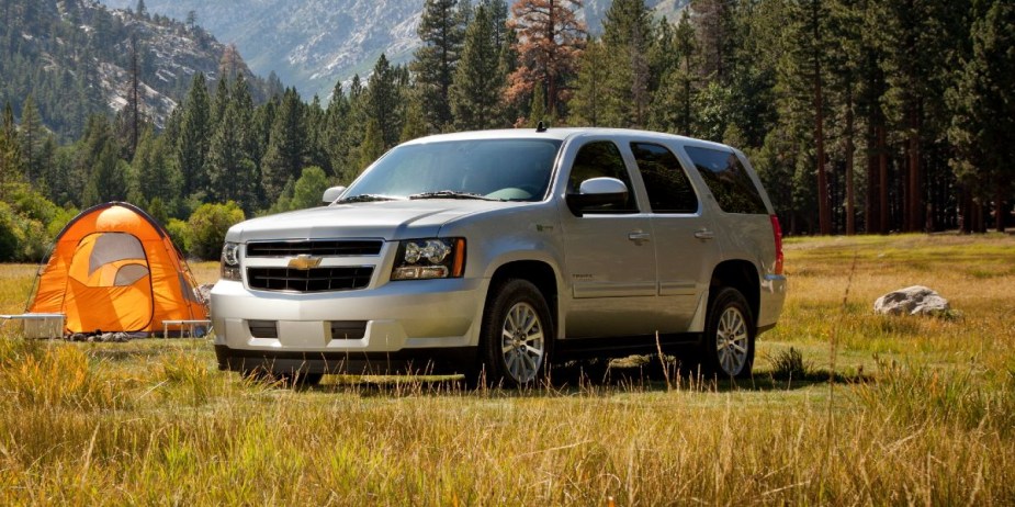 A gray Chevrolet Tahoe Hybrid full-size SUV is parked outdoors. 