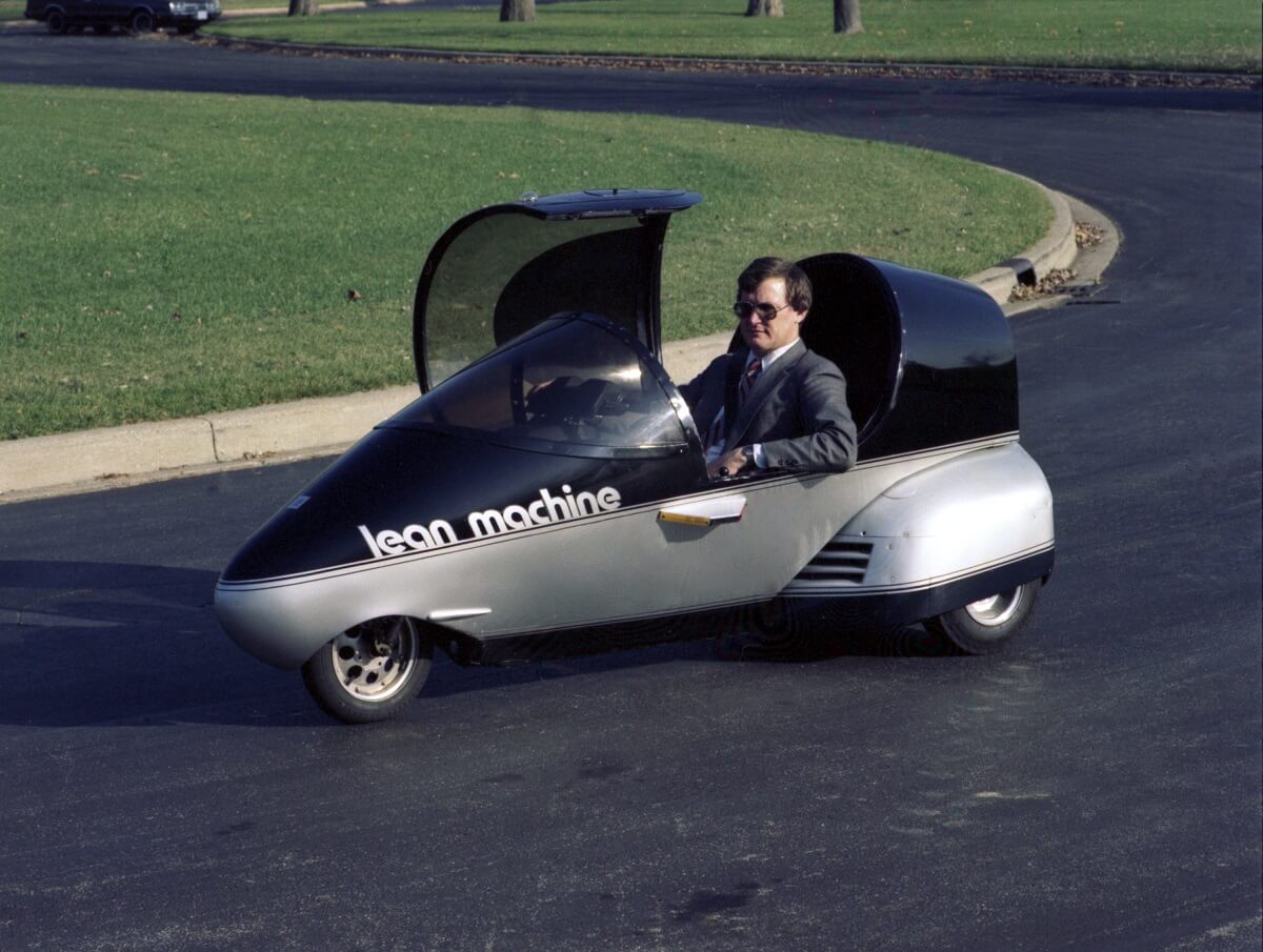 A General Motors concept three-wheeler sits with its canopy open. 