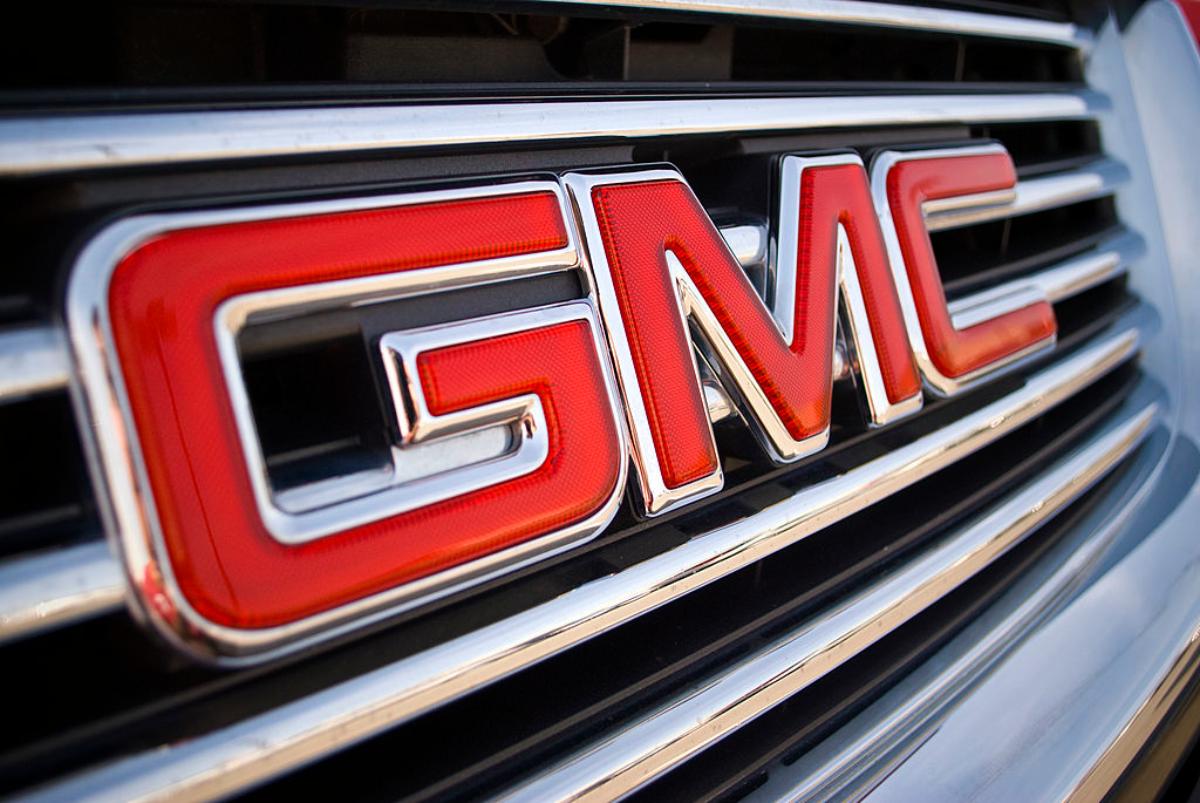 A GMC logo on the front grille of car.