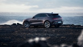 A gray 2023 Genesis GV70 parked in front of a cliff. There are plenty of Genesis GV70 trims to pick from.