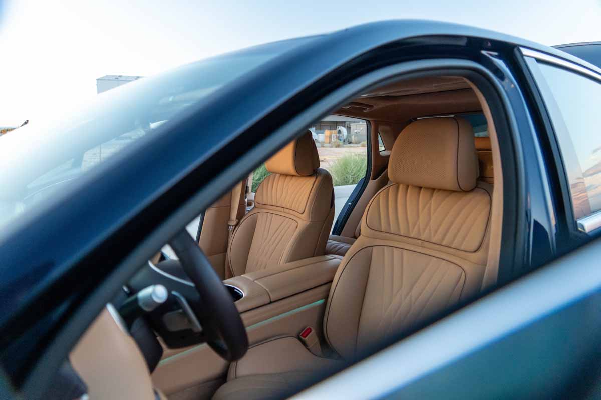 Front seats of Genesis G90 luxury sedan shot through the driver side window