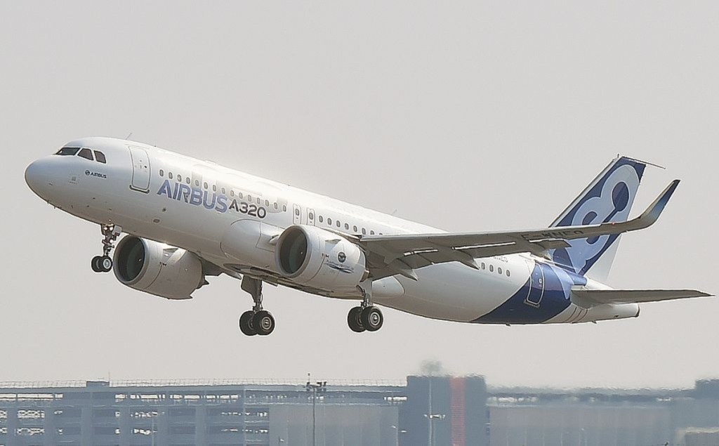 Airbus A320neo airplane flying out of airport