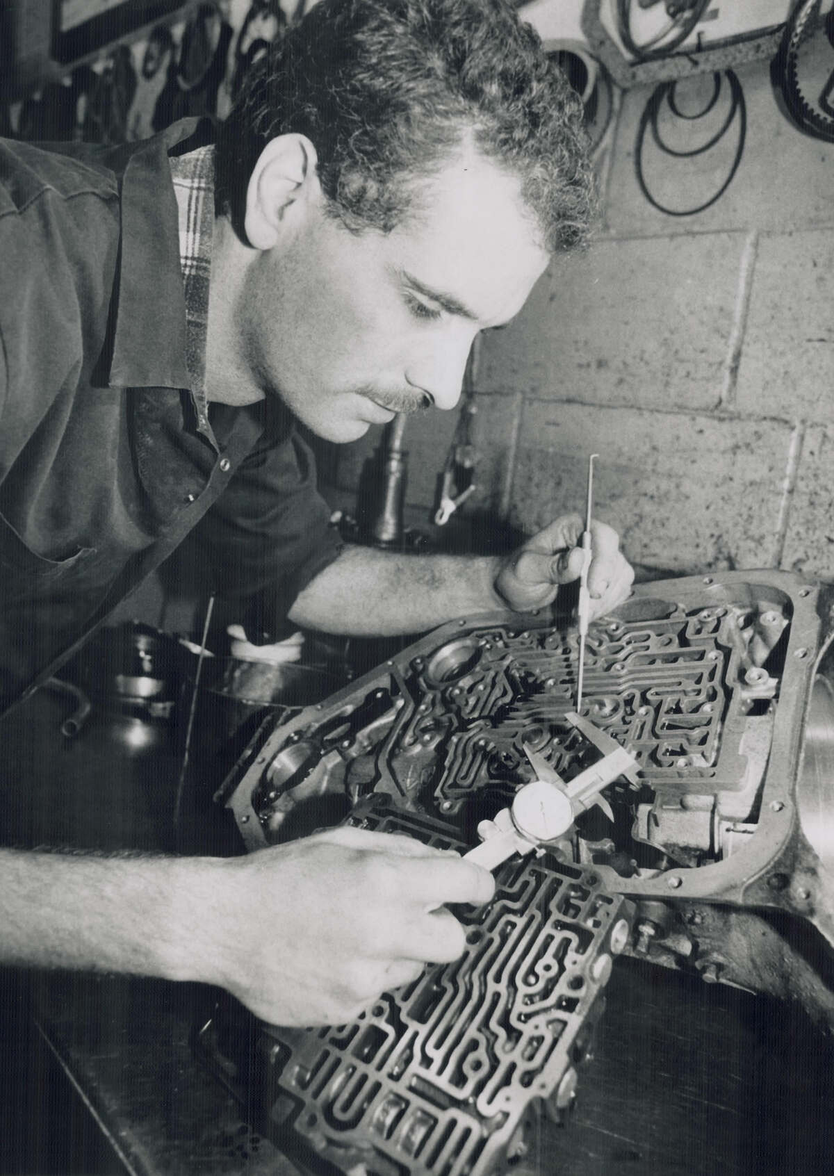 Automatic transmission technician working on transmission