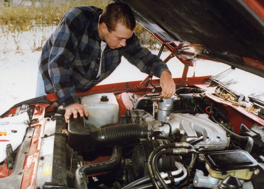 Shade tree mechanic repairing car