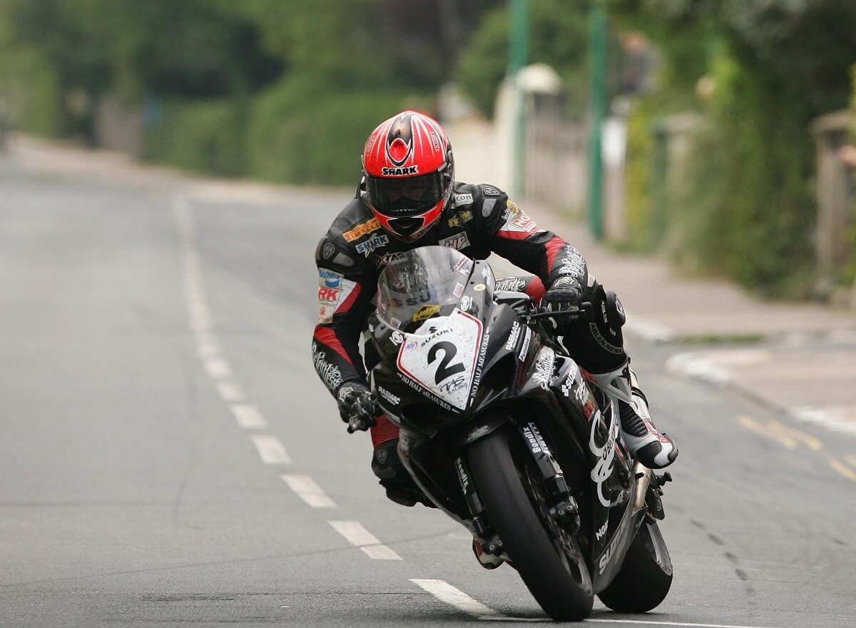 Motorcycle race participant Guy Martin leans around a corner at the Isle of Man TT.