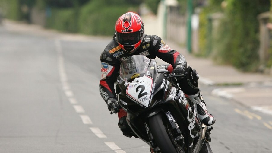 Motorcycle race participant Guy Martin leans around a corner at the Isle of Man TT.