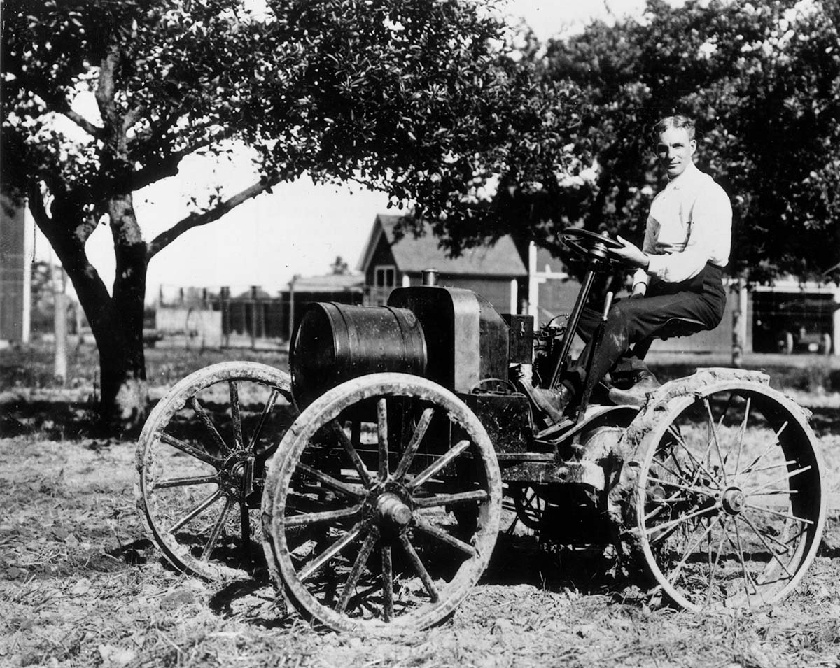Henry Ford sitting on an early Ford automobile with the Model B engine in 1904