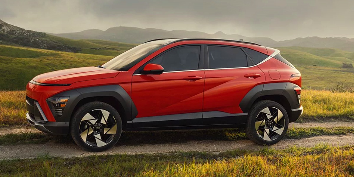 A red 2024 Hyundai Kona is parked.