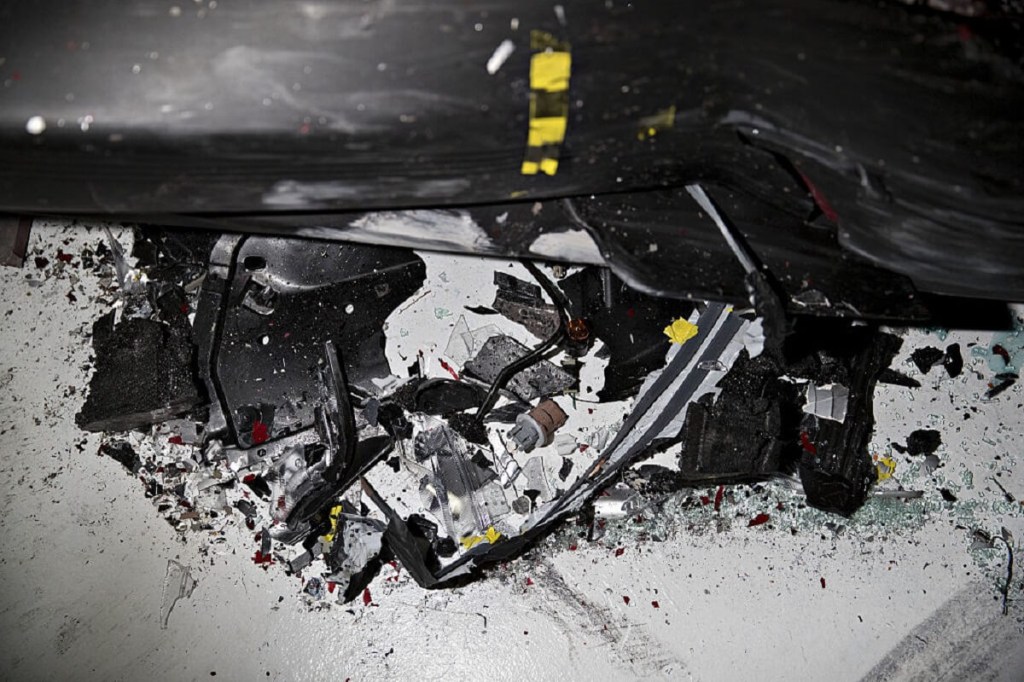 A crashed car shows the aftermath of an IIHS crash test.