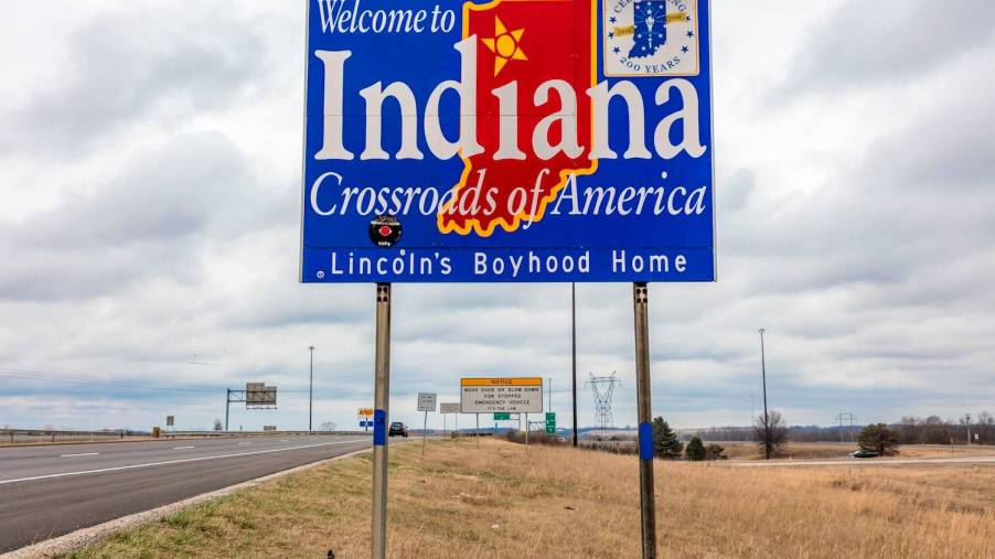 A welcome to Indian sign on interstate highway I-70, a major semi-truck thoroughfare.