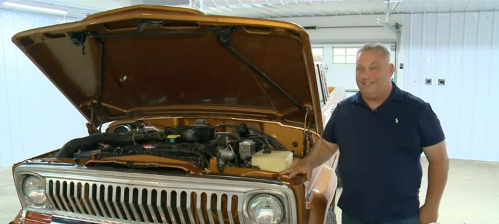 Michael Smith standing next to the Jeep J10 Prototype