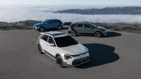 A lineup of three different 2023 Kia Niro models parked. Kia Niro sales are starting to increase.