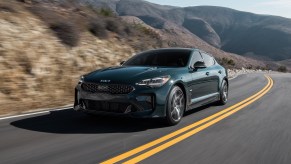 Kia sales indicate that the Kia Stinger, pictured in gray driving on a dry road, is at the bottom of Kia sales.