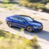 An overhead shot of a speeding blue Volkswagen Arteon. The last Volkswagen Arteon is going on sale for the 2024 model year.