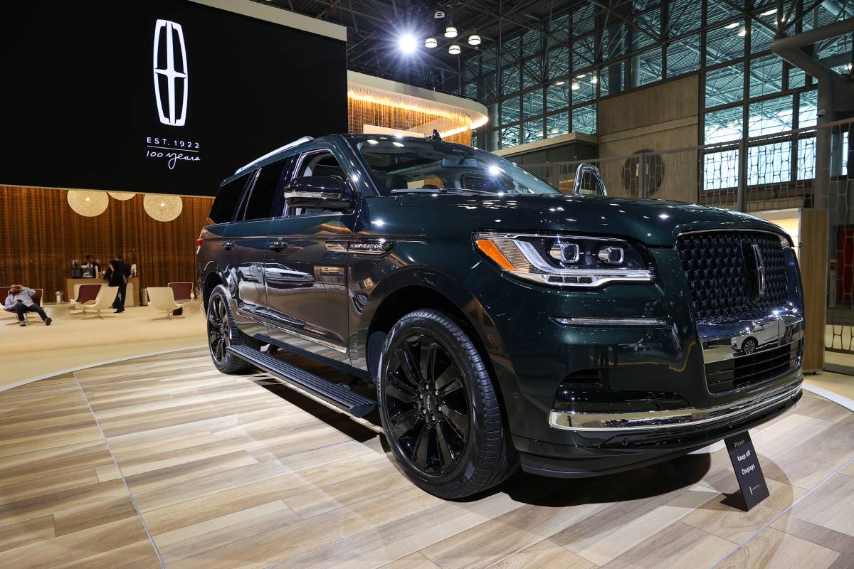 A black Lincoln Navigator on display at an auto show.