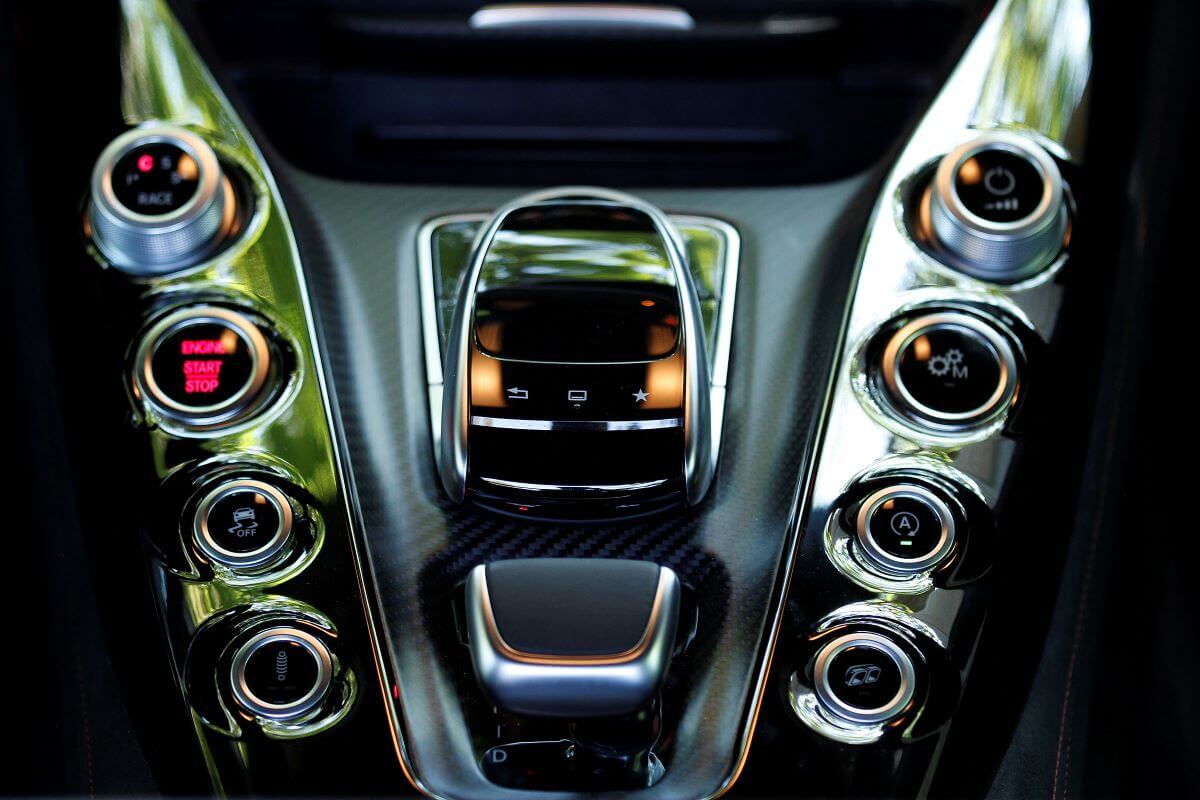 Dials, buttons, and and controls of driving and suspension modes inside a Mercedes-AMG GT S roadster