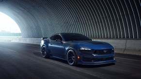 A Dark Ember Metallic Blue 2024 Ford Mustang Dark Horse shows off its new S650 styling in a tunnel.