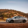 Gray Nissan Maxima driving on a desert road. Nissan Maxima trims offer a bunch of variety for car shoppers