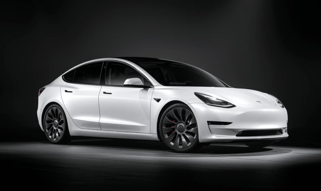White 2023 Tesla Model 3 on black background