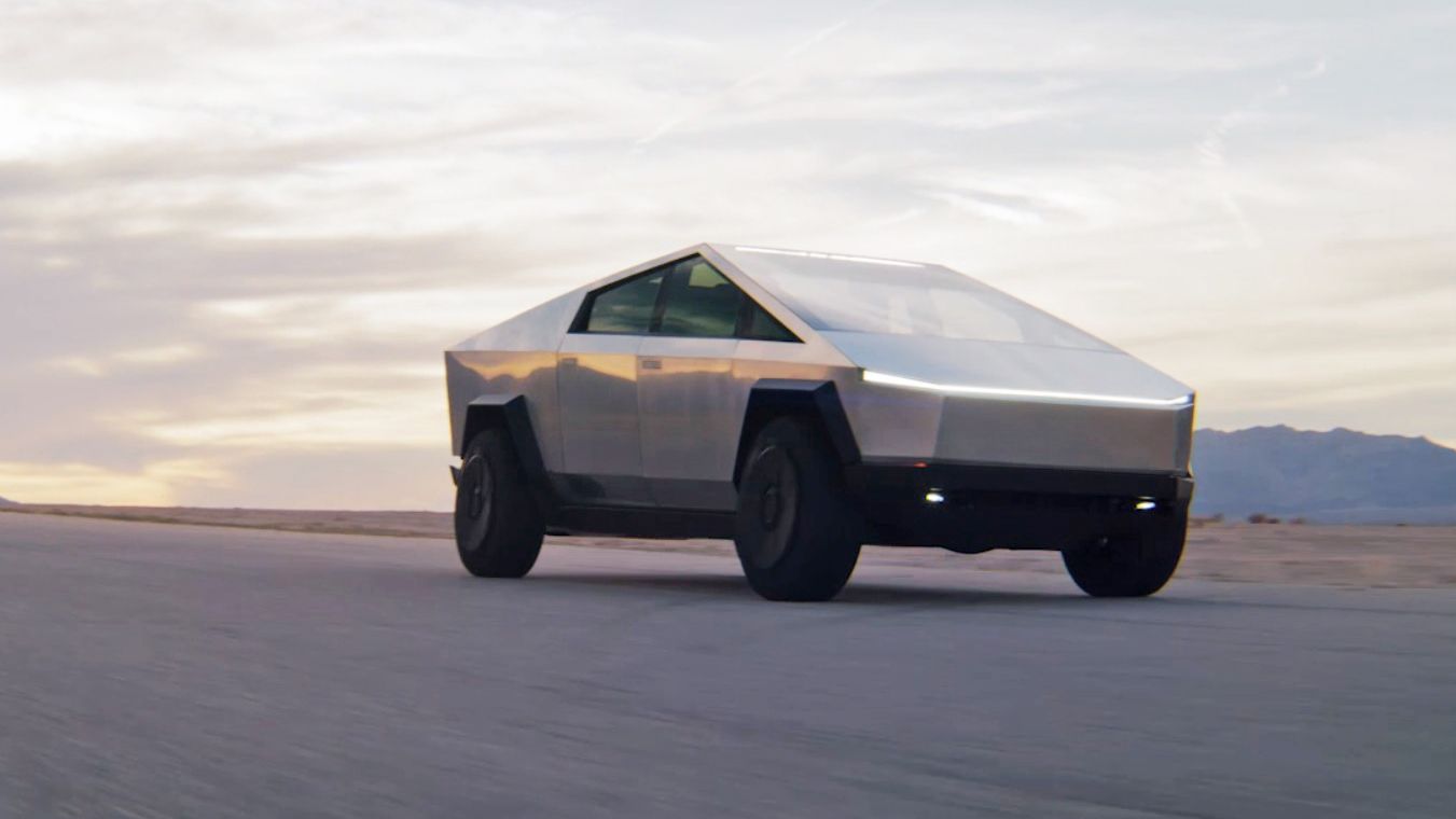 The Tesla Cybertruck driving over desert sand