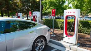 A Tesla EV charges at a Tesla Supercharger