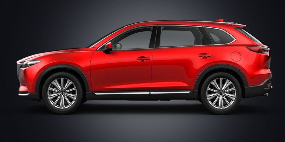 A red Mazda CX-9 midsize SUV is parked. 