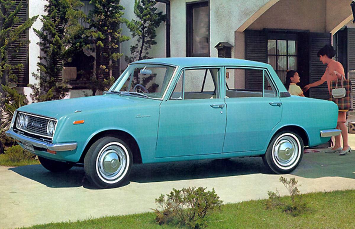 A blue Toyota Corona parked in a driveway.