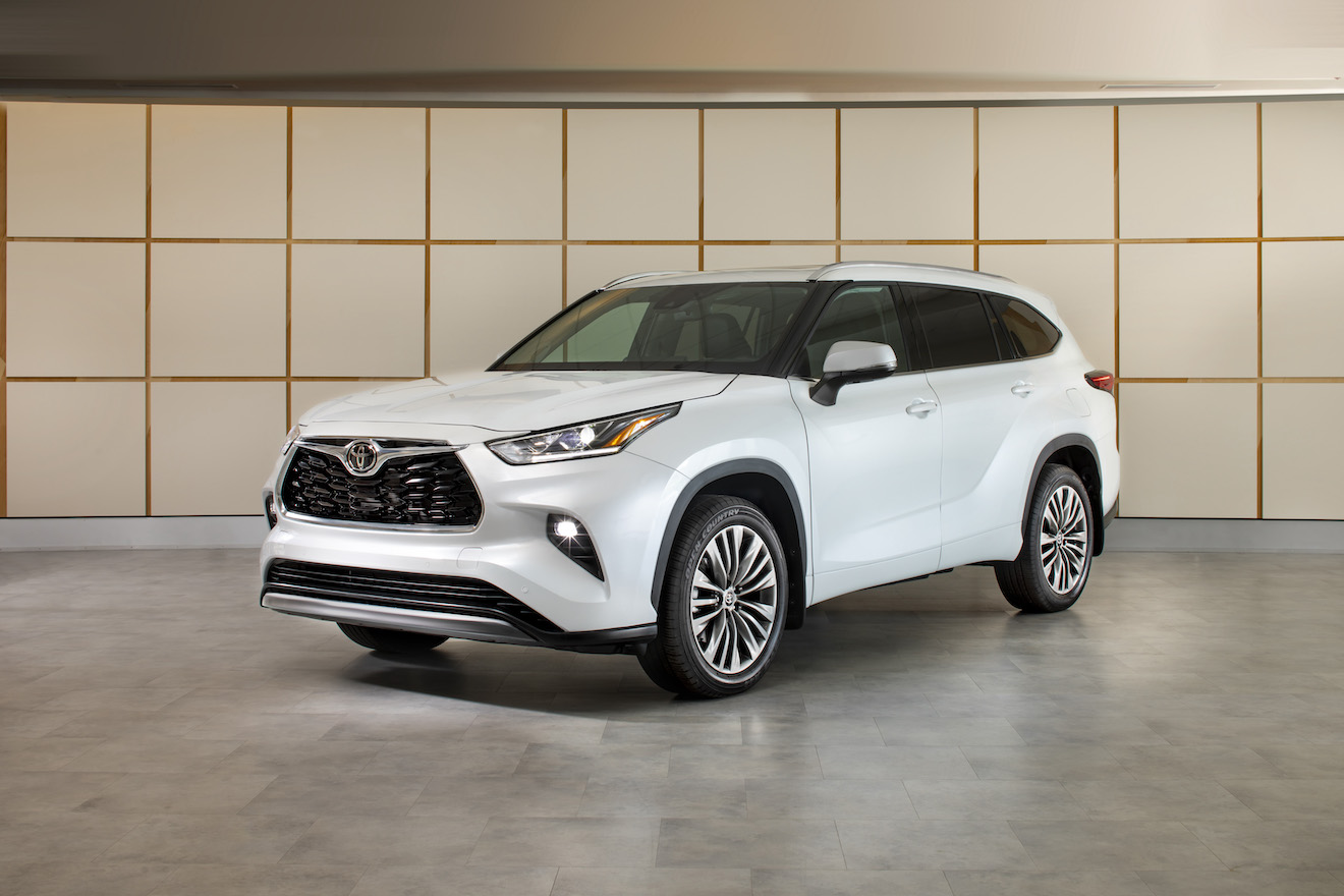 A white 2023 Toyota Highlander on display. The Highlander vs. Explorer debate can help you determine which model to buy next.