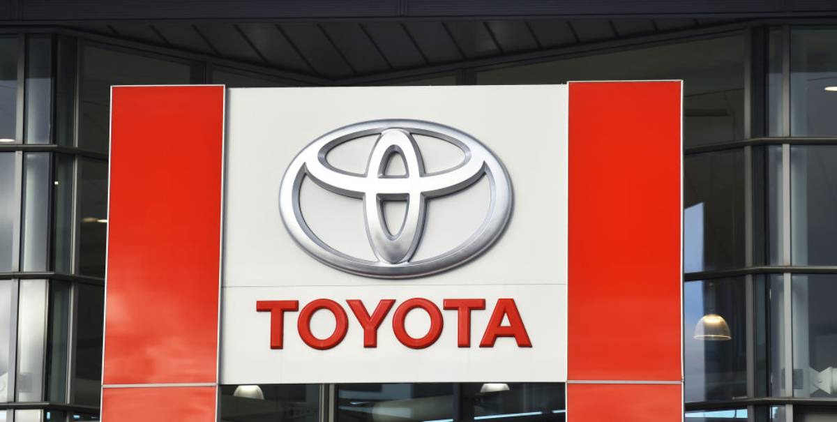 A Toyota logo on display on at a car dealership.