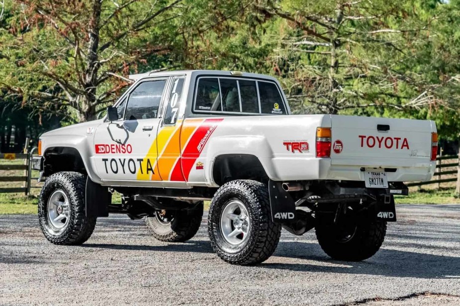 White 4WD Toyota truck with tri-colored racing livery and an SR5 badge.