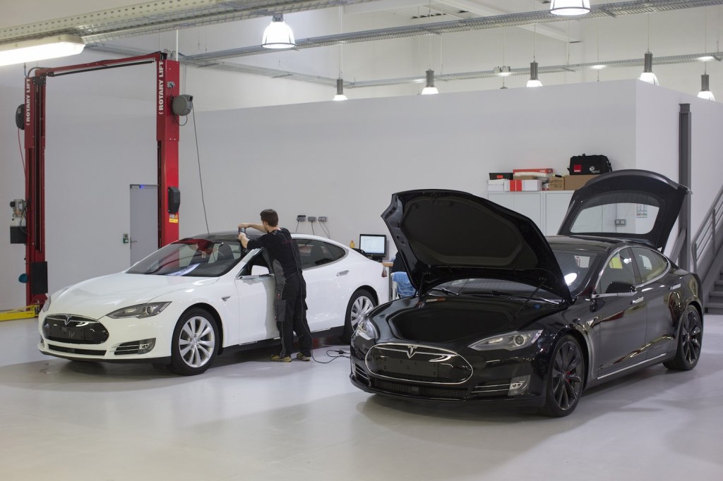 A Tesla Model S used electric car parked in a showroom garage.