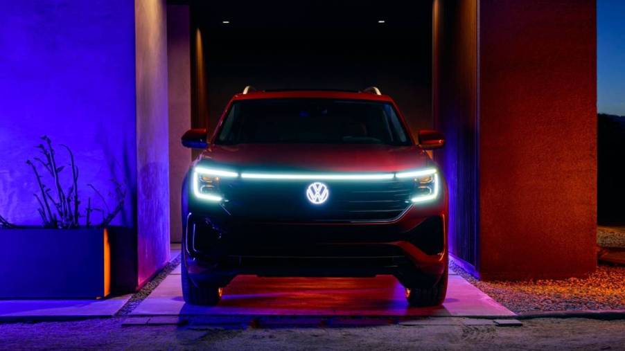 Headlights on a Volkswagen Atlas light up at night.