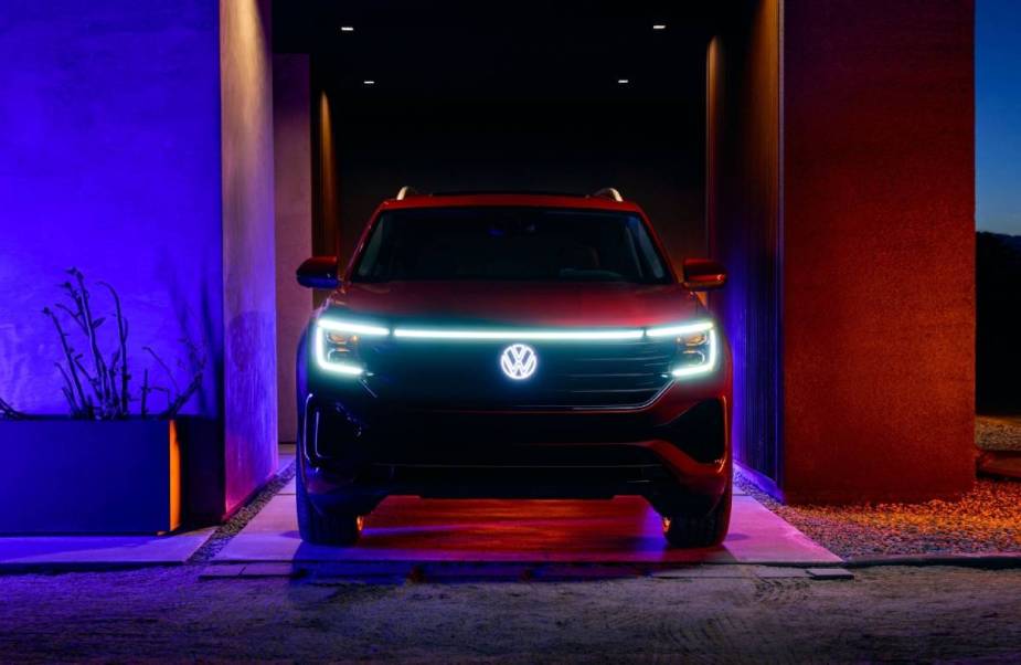 Headlights on a Volkswagen Atlas light up at night.