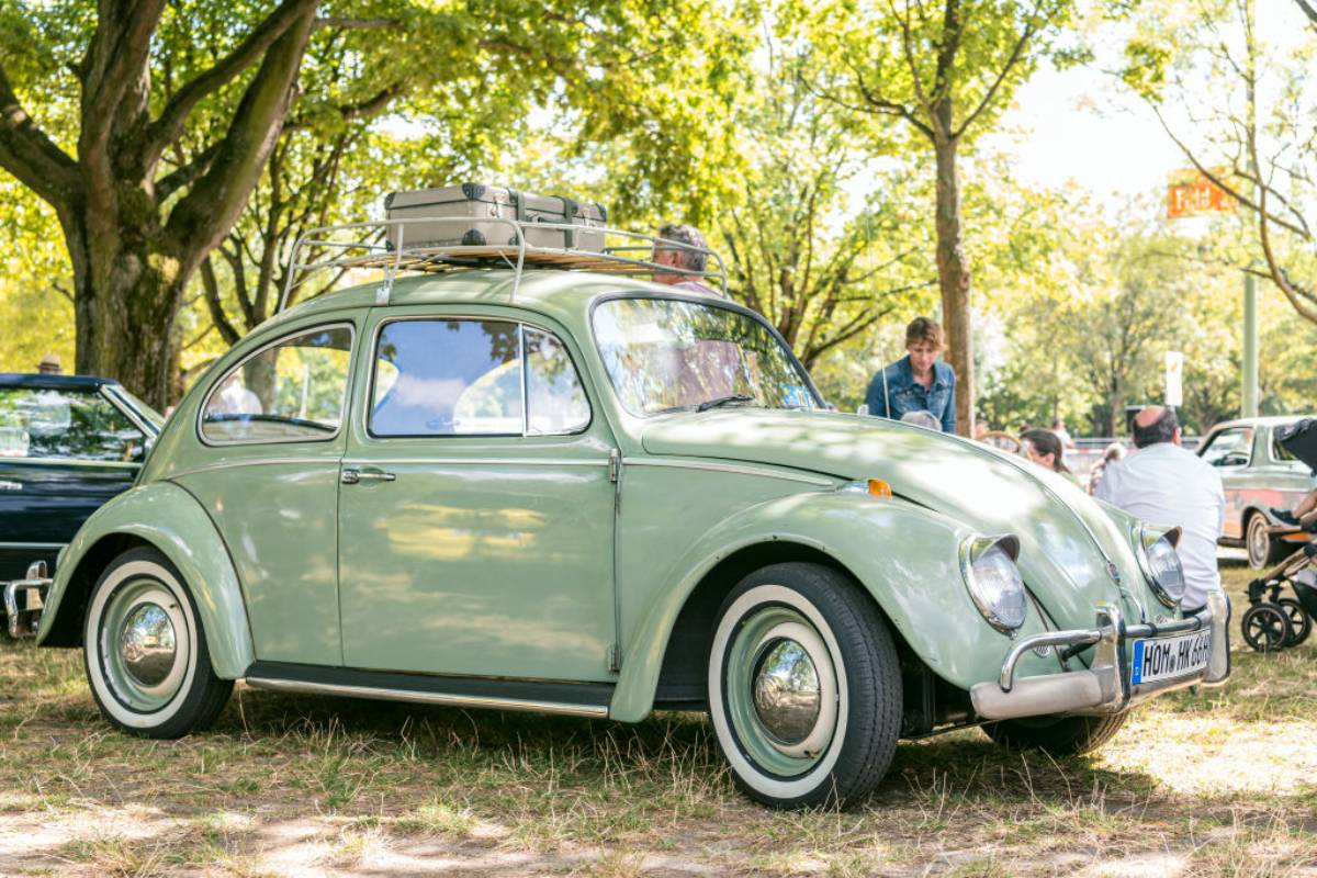 A Volkswagen Beetle on display outside.