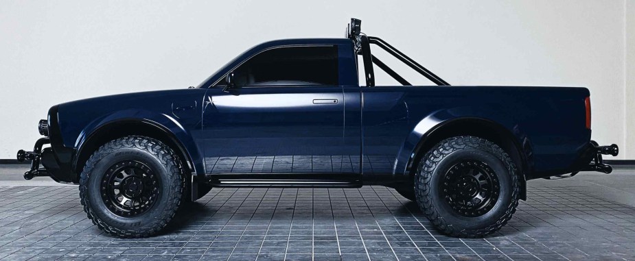 A blue side view of the Alpha Wolf ev pickup truck. 