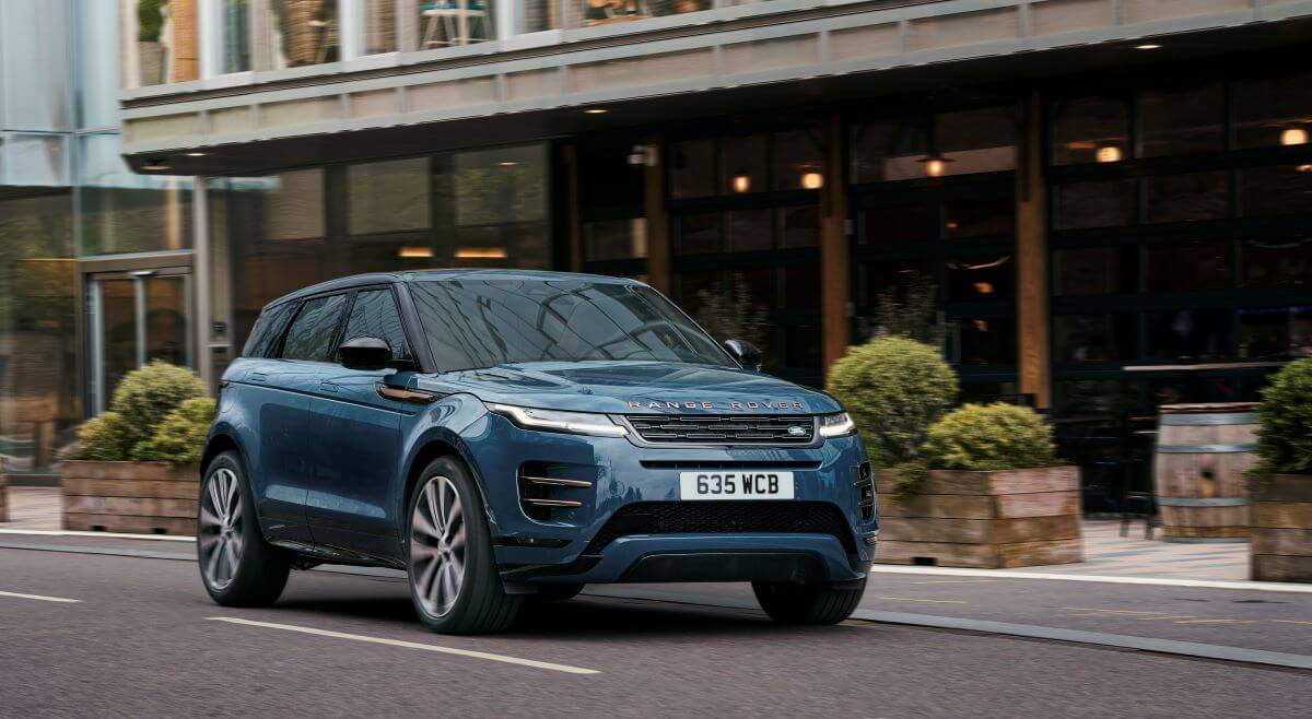 A 2024 Land Rover Range Rover Evoque Autobiography subcompact luxury SUV model driving past cafes