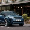 A 2024 Land Rover Range Rover Evoque Autobiography subcompact luxury SUV model driving past cafes