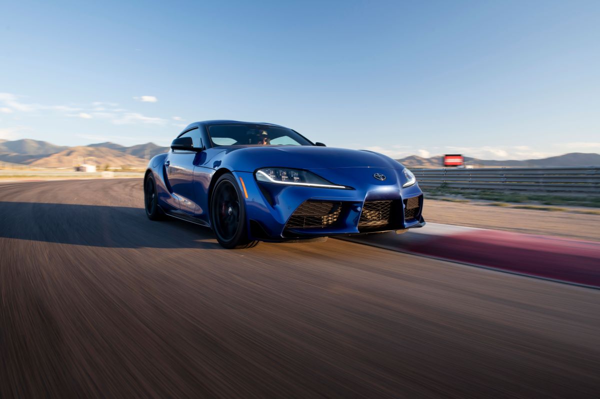 A 2024 Toyota GR Supra 3.0 Premium sports car coupe model in Stratosphere blue paint on a racetrack