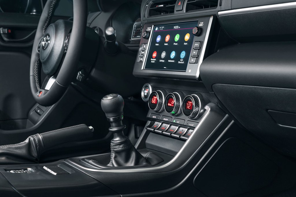 Black interior 2023 Toyota GR86 with manual transmission showing infotainment system