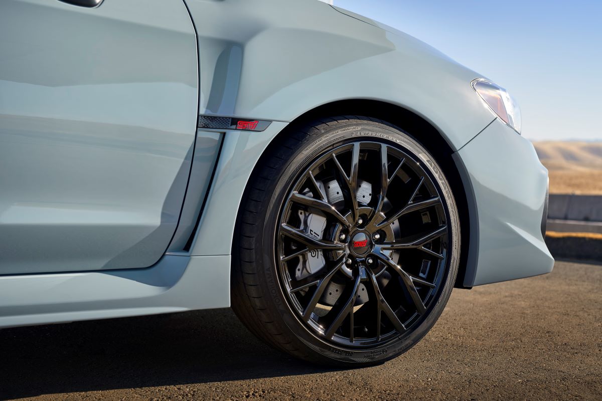 A shot of STI badging, wheel, brake, and tire choices on a 2019 Subaru WRX STI series model in gray