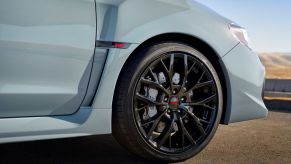 A shot of STI badging, wheel, brake, and tire choices on a 2019 Subaru WRX STI series model in gray